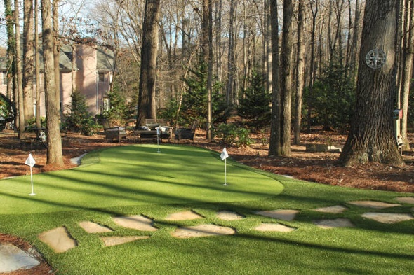 Atlanta backyard putting green with flags and trees